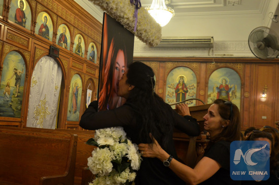 A relative kisses the picture of Yara Farouk, one of the victims on the crashedEgyptAir MS804 as a crew member, at a church in Cairo, Egypt, May 21, 2016. (Xinhua Photo)