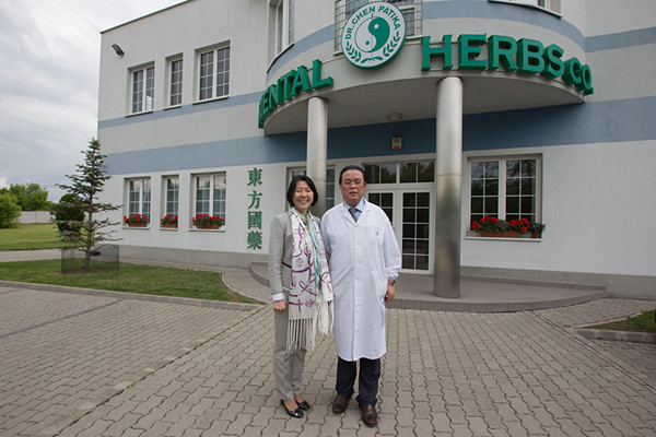 Chen Zhen and his wife pose in front of their TCM factory in Budapest, capital city of Hungary, May 19, 2016. (Photo/Xinhua)