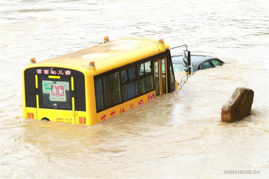 Vehicles are seen on a flooded road in Shunchang County, Nanping City of east China's Fujian Province, May 8, 2016. (Photo/Xinhua)