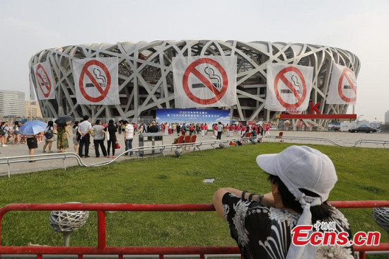 Anti-smoking banners were displayed on the iconic Bird's Nest National Stadium during an event marking World No Tobacco Day in Beijing, capital of China, May 31, 2015. (Photo: China News Service/Wang Jun)