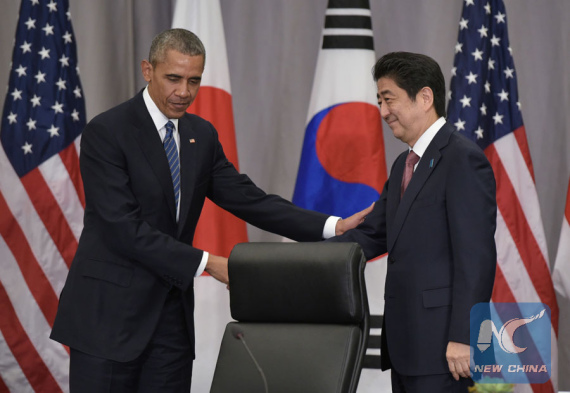 U.S. President Barack Obama (L) shakes hands with Japanese Prime Minister Shinzo Abe following a trilateral meeting with South Korean President Park Geun-hye on the sidelines of the Nuclear Security Summit at the Walter E. Washington Convention Center in Washington D.C., the United States, March 31, 2016.  (Photo/Xinhua)