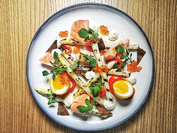 Grilled white asparagus with salmon (above) at Feast restaurant. (Photo provided to China Daily)