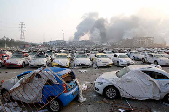 Damaged cars are pictured in Tianjin Port on Aug 13, 2015. (Shan Haihan / For China Daily)