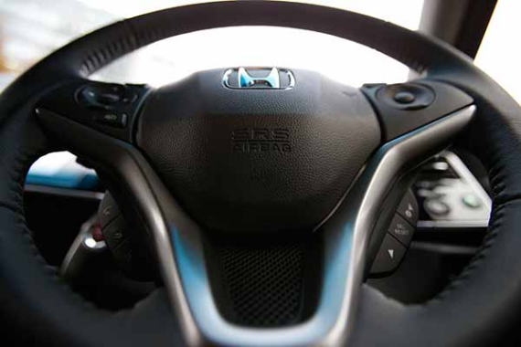 An airbag logo is seen on a steering wheel of Honda Motor Co's all-new hybrid sedan "Grace", which installed the airbag made by Takata Corp, during its unveiling event in Tokyo Dec 1, 2014. (Toru Hanai / For China Daily)