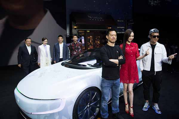 Co-founder and head of Le Holdings Co Jia Yueting (front left), actress Tang Yan (front center), actor Sun Honglei (front right), poses in front of all-electric battery concept car LeSEE with guests during a ceremony in Beijing, China April 20, 2016. (Photo provided to chinadaily.com.cn)