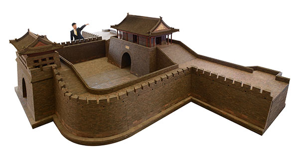 The model of Guangqu Gate and its watchtower with a man standing next to it.