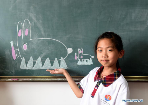 Students of Yudao School for children of migrant workers made chalkboard paints to express their wishes for the Children's Day in Hangzhou, capital of east China's Zhejiang Province, May 31, 2016. (Photo: Xinhua/Han Chuanhao)