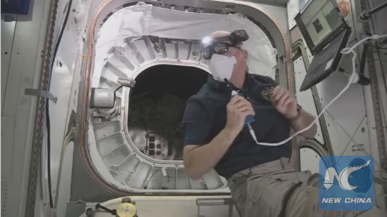NASA astronaut Jeff Williams floats in front of the entrance to the Bigelow Expandable Activity Module (BEAM)