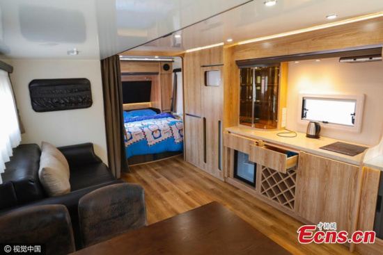 A scrapped bus has been transformed into a room at a scenic spot in Taiyuan City, the capital of North Chinas Shanxi Province, May 29, 2016. One air-conditioned room, equipped with a kitchen, TV, and bathroom with toilet, costs less than 200 yuan ($31) a day and mainly attracts young lovers. (Photo/CFP)
