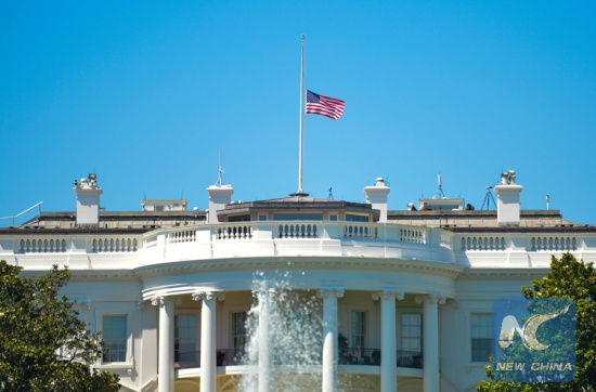 The U.S. national flag flies at half-mast at the White House to mourn the victims of the mass shooting at a gay night club in Orlando, in Washington D.C., the United States, June 12, 2016. (Photo: Xinhua/Bao Dandan)