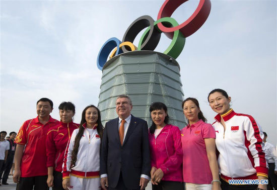  International Olympic Committee President Thomas Bach (4th Left) poses with representatives of Olympic champions of China during the opening ceremony of the Beijing Olympic Tower in Beijing, capital of China, on June 12, 2016. (Photo: Xinhua/Ju Huansong)