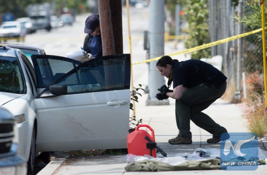 A police takes photos for evidence in Santa Monica, California, the United States, June 12, 2016. Santa Monica police arrested a man armed with a gun and seized a car with explosives here on Sunday morning hours before a gay pride parade in West Hollywood. (Photo: Xinhua/Yang Lei)