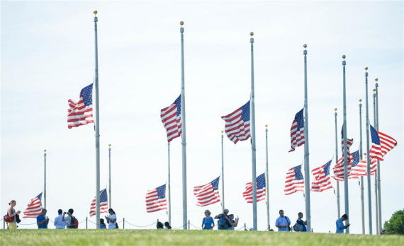 The U.S. national flag flies at half-mast at the Washington Monument to mourn the victims of the mass shooting at a nightclub in Orlando, in Washington D.C., the United States, June 13, 2016. (Photo: Xinhua/Bao Dandan)