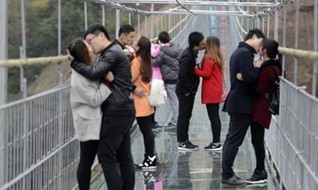 Young couples posed to kiss to welcome the Singles' Day in Pingjiang county, Central Chinas Hunan province on November 11, 2015. (PhotoChina News Service/ Yang Huafeng)