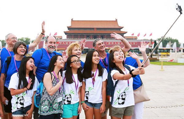Adopted Chinese youngsters and their family members take a selfie during a visit to Tian'anmen Square in Beijing on Tuesday. Zou Hong / China Daily