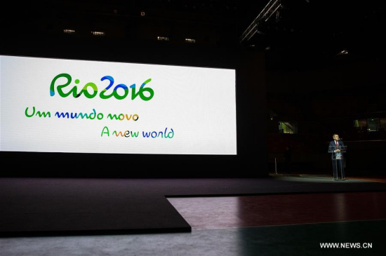 President of the International Olympic Committee (IOC) Thomas Bach delivers a speech as the slogan of the Rio 2016 A new world is shown on the screen at the unveiling ceremony held at the Future Arena in the Barra Olympic Park in Rio de Janeiro, Brazil, on June 14, 2016. (Xinhua/Li Ming)