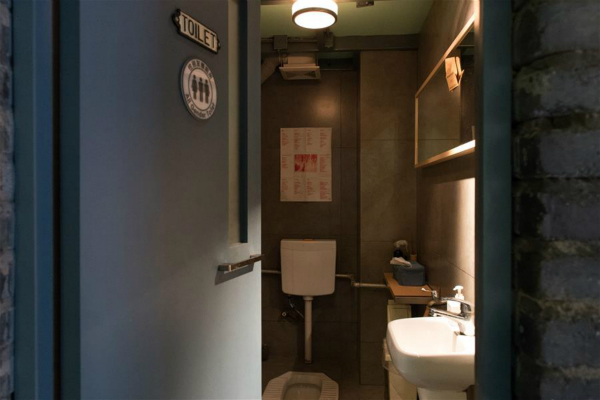 An All Gender Toilet sign is seen at a gate of Twin City Cafe on the Fangjia Alley in Beijing, capital of China, June 16, 2016. The Beijing Gender Health Education Institute launched the All Gender Toilets Program in Beijing recently in hope of helping the public disregard gender distinctions. (Xinhua/Wu Kaixiang)