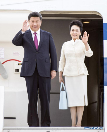 Chinese President Xi Jinping (L) and his wife Peng Liyuan wave as they arrive at the airport in Warsaw, Poland, June 19, 2016. Xi Jinping arrived in Warsaw Sunday for a state visit to Poland. (Photo: Xinhua/Xie Huanchi)