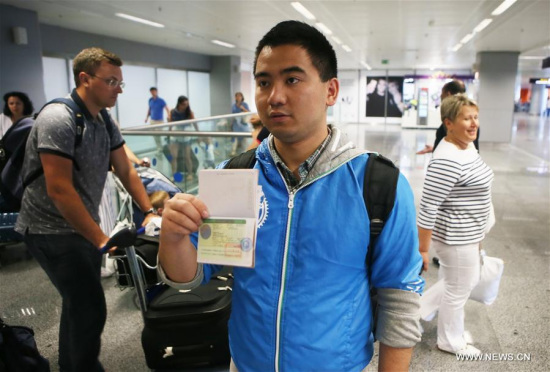 A Chinese traveller displays his visa-on-arrival at the Boryspil airport in Kiev, Ukraine, on June 20, 2016. (Xinhua)