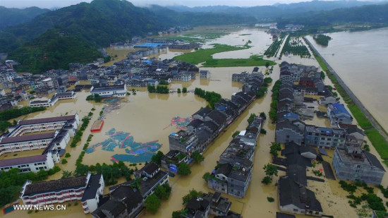 Photo taken on June 20, 2016 shows the bird's eye view of flood-encircled Liye Township in Longshan County, cenral China's Hunan Province. (Xinhua/Zhang Jin)