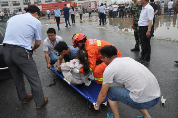 An injured woman is placed on a stretcher by rescuers in Funing County, east China's Jiangsu Province, June 23, 2016.  (Photo/Xinhua)