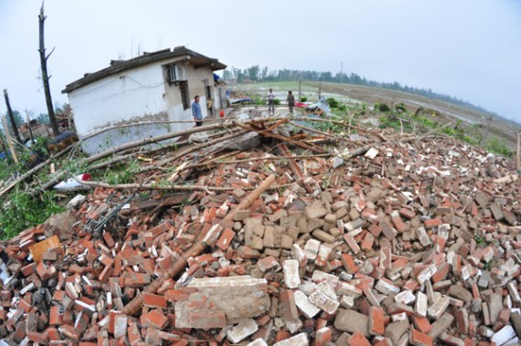 Villagers survey the rubble of a collapsed house after a tornado struck Funing in Jiangsu province on Thursday. (Provided to China Daily)