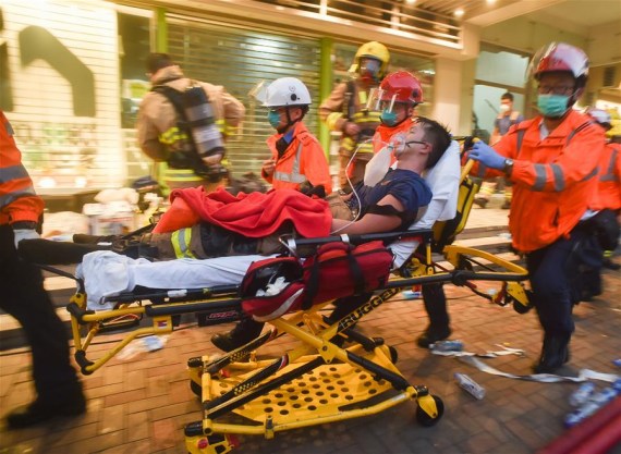 An injured firefighter is wheeled to a hospital in Hong Kong, south China, June 23, 2016.  (Photo: Xinhua/Ng Wing Kin)
