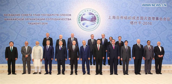 Chinese President Xi Jinping (6th R front) poses for a group photo with other participants and observers of the 16th SCO Council of Heads of State meeting in Tashkent, Uzbekistan, June 24, 2016. (Xinhua/Ding Lin) 