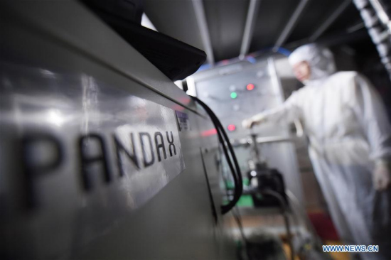 An experimenter of Dark Matter Experiment PandaX, which means Particle and Astrophysical Xenon Detector, checks facilities in the Jinping Underground Laboratory, located at 2,400 meters under the surface of Jinping Hydropower Station, in Sichuan Province, June 28, 2016.