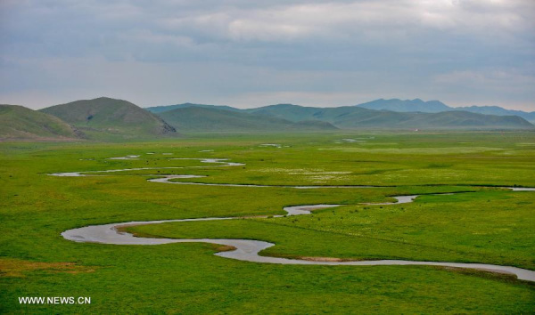Photo taken on July 12, 2013 shows the view of local pasture in West Ujimqin Banner, north China's Inner Mongolia Autonomous Region. The pasture is part of the Xilingol, China's best preserved grassland which covers an area of 202,580 square kilometers. (Xinhua/Ren Junchuan)