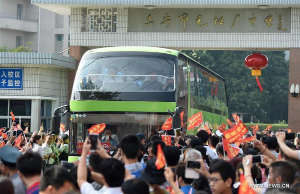 Parents and local residents see off G12 students of Maotanchang High School (including Jin'an High School) in Maotanchang Town of Lu'an City, east China's Anhui Province, June 5, 2016. A total of 19 shuttle buses carrying nearly 1,000 students set off here to examination venues in Lu'an City, for the upcoming national college entrance exam, or "gaokao", on Sunday. (Photo: Xinhua/Guo Chen)