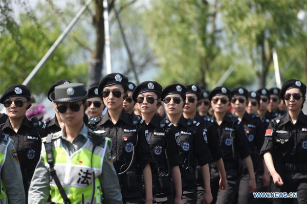 Members of a patrol under West Lake scenic area administrative department walk at the West Lake in Hangzhou, east China's Zhejiang Province, May 1, 2016. (Photo: Xinhua/Huang Zongzhi)