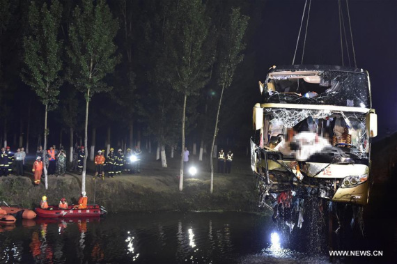 Rescue workers salvage the accident bus in Baodi section of north China's Tianjin, on July 2, 2016. A bus carrying 30 people rushed out of an expressway Friday night in north China's Tianjin City, and only four people were found alive as of 2 a.m. Saturday, according to rescuers. (Xinhua/Yue yuewei)