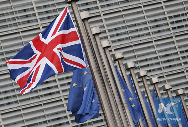 Photo taken on Jan. 29, 2016 shows the UK and EU flags outside the European Commission headquarters in Brussels, Belgium. (Xinhua/Ye Pingfan)