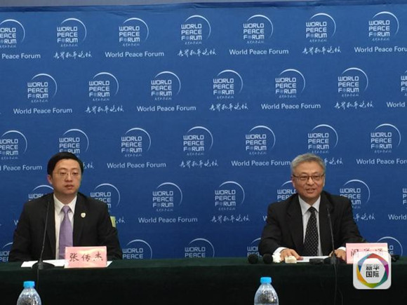 Secretary-General of World Peace Forum Yan Xuetong (R) is on a press briefing on July 6, 2016. (Xinhua/Du Baiyu)