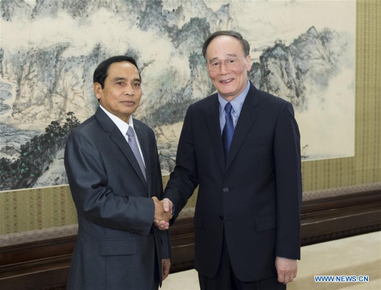 Wang Qishan (R), secretary of the Communist Party of China Central Commission for Discipline Inspection, meets with a delegation headed by Bounthong Chitmany (L), president of the ruling Lao People's Revolutionary Party Central Committee's Commission for Inspection, in Beijing, capital of China, July 7, 2016. (Xinhua/Wang Ye) 