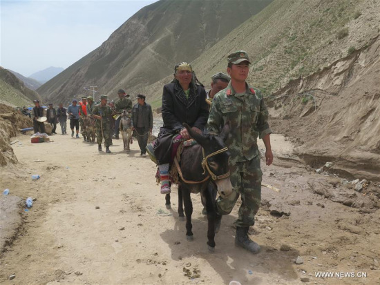 Villagers of Kokyar Township head to a relocation place in Yecheng County of Kashgar Prefecture, northwest China's Xinjiang Uygur Autonomous Region, July 9, 2016. A landslide here has claimed 35 lives and 198 villagers have been transferred to safe places. (Xinhua/Ma Kai)