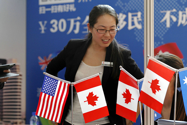 A mother of a student reviews information at a recent promotional event for US and Canadian properties in Beijing. (Photo/China Daily)