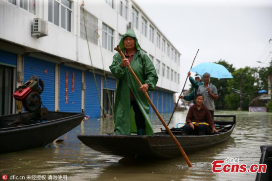 Residents use a boat for transportation in the flood-hit Langxi County of Xuancheng City, East China��s Anhui Province, July 11, 2016. (Photo/IC)