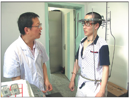 Doctor Liang Yijian talks with one of his patients who suffers from scoliosis at No 3 Hospital in Chengdu, Sichuan province. Huang Zhiling / China Daily