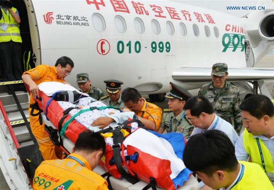 Chen Ying, Chinese peacekeeper in South Sudan, was carried down a medical rescue plane in Beijing, capital of China, July 17, 2016. Xinhua/Zhang Yongjin)