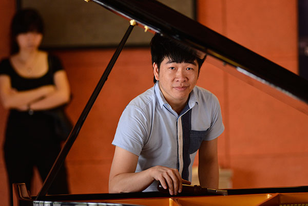 Chen Deran, a senior piano tuner with the Guangzhou Pearl River Piano Group, prepares to tune a piano in Guangzhou, Guangdong province. Provided to China Daily
