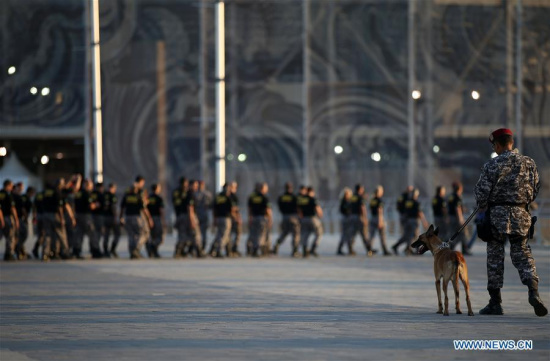 A National Force officer walks with a patrol dog in front of the Olympic Aquatics Stadium after the inauguration ceremony of the integrated security operation for Rio 2016 Games in Rio de Janeiro, Brazil, on July 5, 2016. (Photo/Xinhua)
