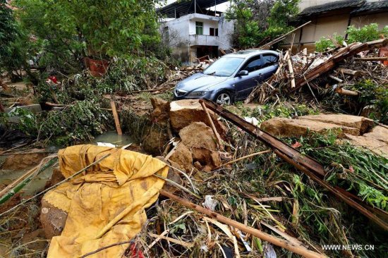A car is buried in messes at Bandong Township after flooding in Minqing County, southeast China's Fujian Province, July 11, 2016.  (Xinhua/Zhang Guojun)