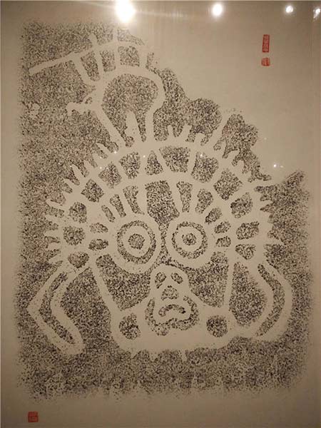 A rubbing of a solar deity is among exhibits at the ongoing rock art show in Beijing. Photos by Wang Kaihao / China Daily