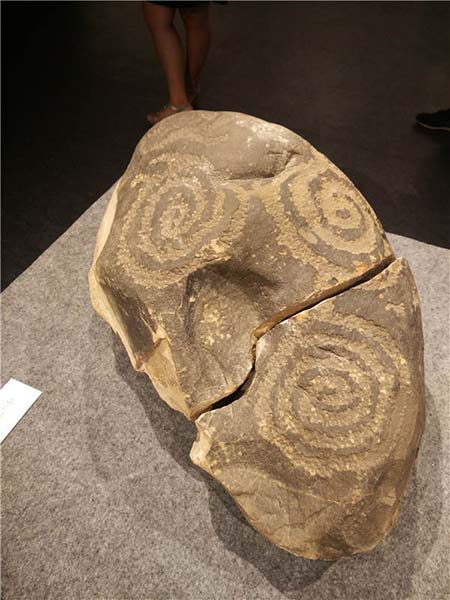 An ancient stone carving is among exhibits at the ongoing rock art show in Beijing. Photos by Wang Kaihao / China Daily