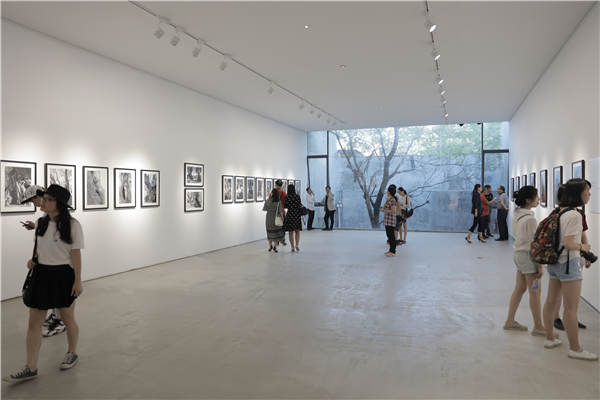 People visit the ongoing exhibition Meet Renoir Under Olive Trees in the 798 Art Zone in Beijing. Photos provided to China Daily