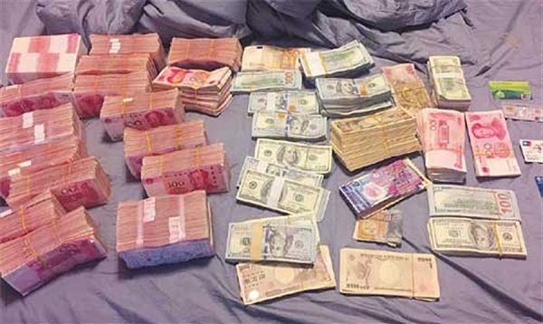 Banknotes seized from the house of one of the suspects who were detained for running an illegal foreign exchange business in Shanghai.(Ti Gong)