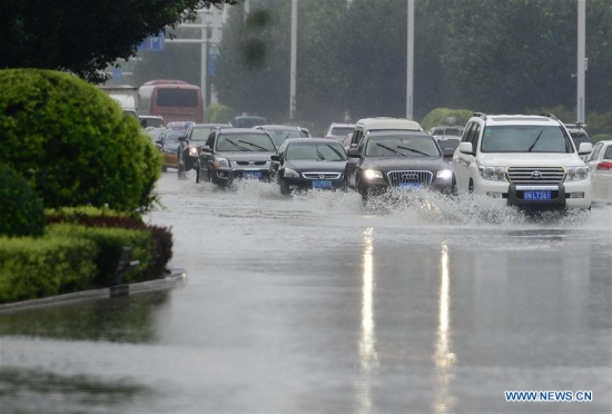 Cars drive on a waterlogged road in Shijiazhuang, capital city of north China's Hebei Province, July 20, 2016. A heavy rain hit the middle and southern areas of Hebei Province in last three days. Precipitation in many cities including Handan, Xingtai and Shijiazhuang reached 630 mm. (Xinhua/Zhu Xudong)