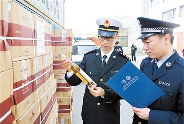 Shanghai Customs officials check imported ice wines. Four people have been arrested for deliberately underpricing the imported wines and evading customs tariffs.(Zhang Jie)